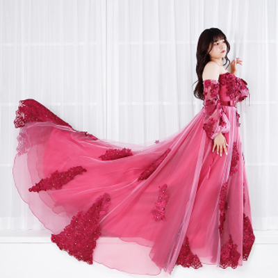 華やかなピンクのロングドレスを着用した女性のポーズカット